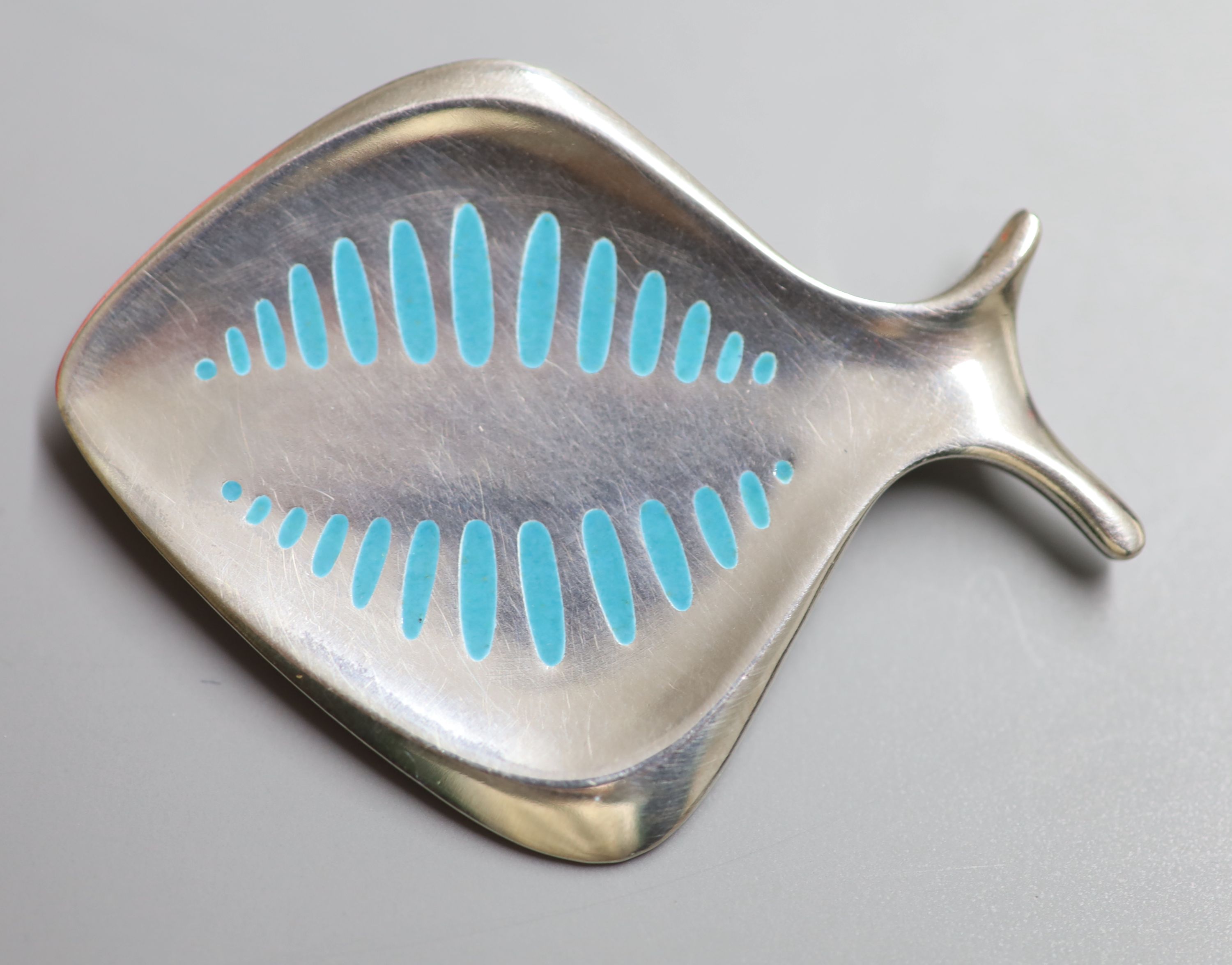 A Georg Jensen 925 and pale blue enamel stylised fish brooch, design no. 343, 57mm, gross 20.3 grams.